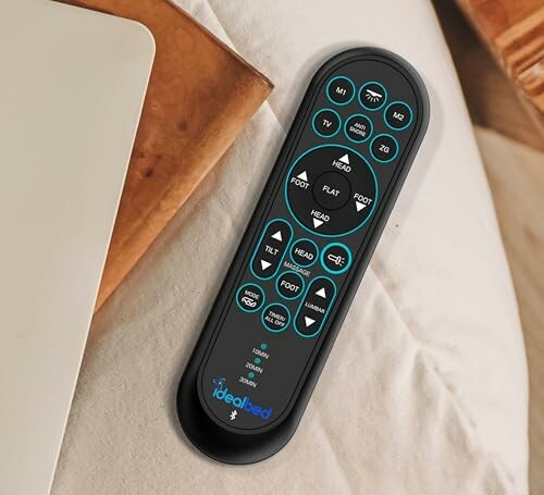 Remote control for adjustable bed on a table.