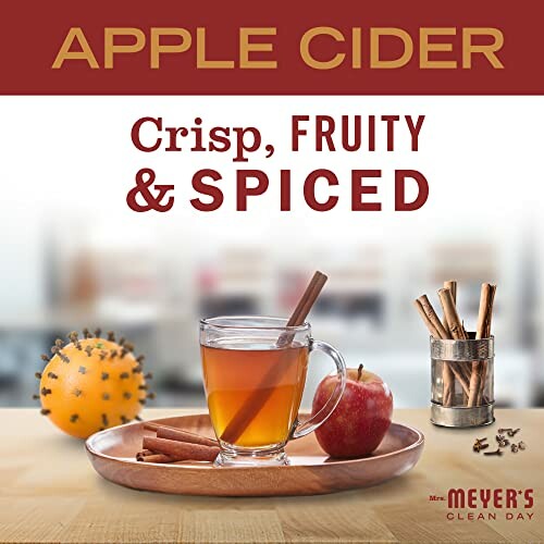 Apple cider with cinnamon, apple, and spiced decor