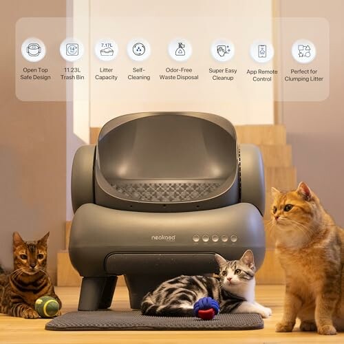 Automatic self-cleaning cat litter box with three cats nearby.