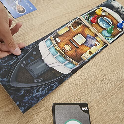 Hand moving a boat-shaped board game piece with cards and tokens.