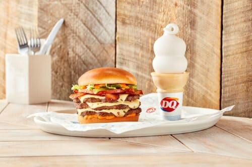 Burger and ice cream cone on a tray with wooden background.