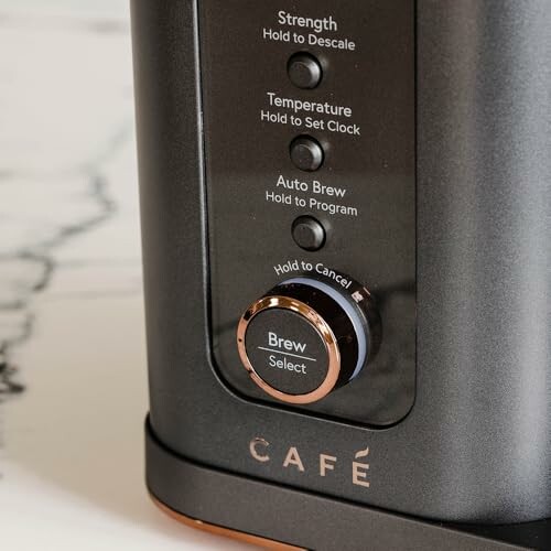 Close-up of Café coffee maker control panel with buttons for strength, temperature, and auto brew.