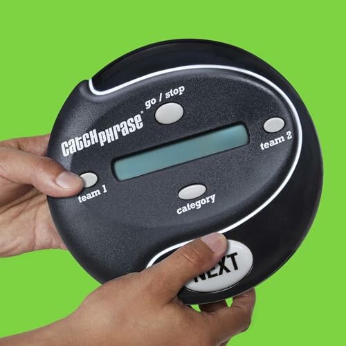 Hands holding electronic Catchphrase game device