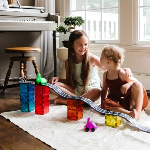 Two children playing with colorful toy cars and blocks indoors.