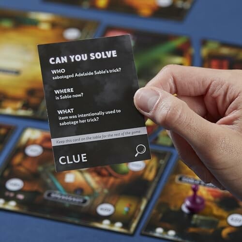 Person holding a Clue game card with mystery questions.