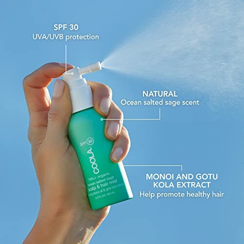 Hand holding COOLA organic scalp and hair mist SPF 30 being sprayed.