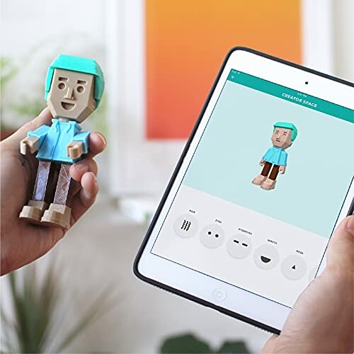 Person holding a customizable figurine next to a tablet displaying design options.