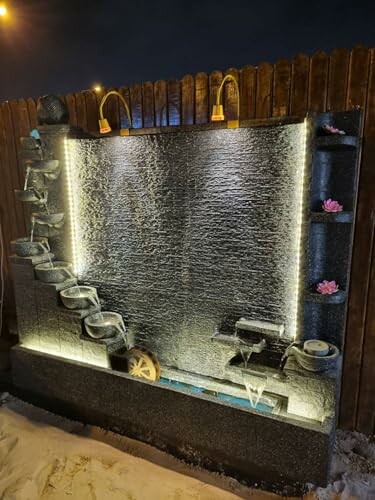 Decorative water fountain with lights and cascading bowls.