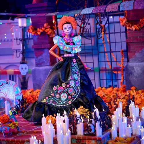 Colorful Dia de los Muertos doll surrounded by candles and decorations.