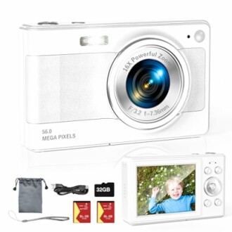 White digital camera with accessories including memory cards, cable, and pouch.