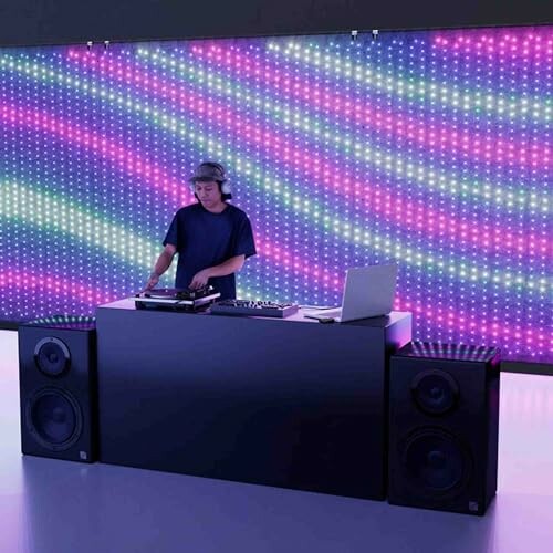 DJ performing with LED wall backdrop