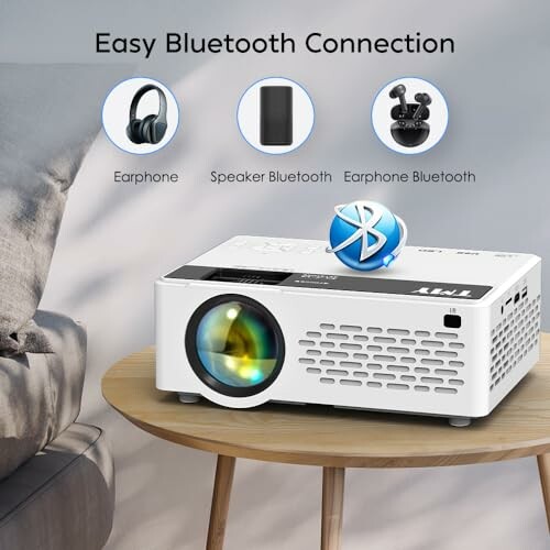 Projector on table with Bluetooth connection options for earphones and speakers.