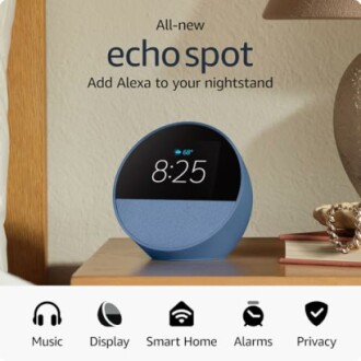 Echo Spot smart speaker on a nightstand displaying time.