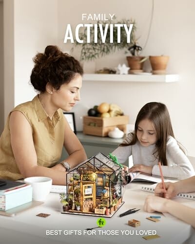 Mother and daughter assembling a miniature greenhouse model together.