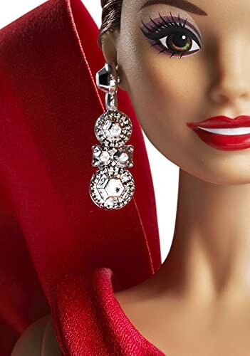 Fashion doll with red dress and sparkling earrings.