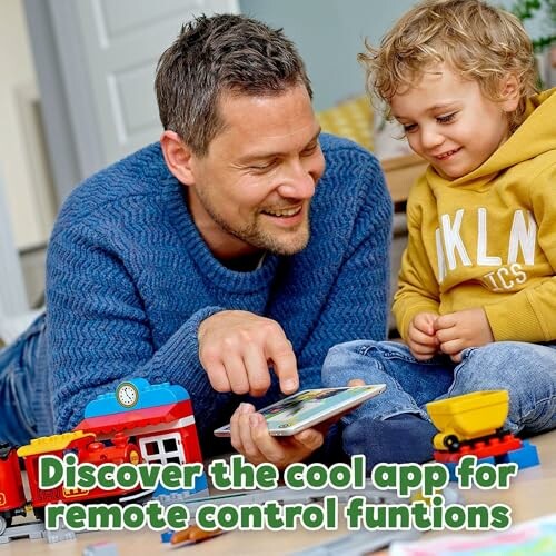 Father and son playing with a toy and tablet, promoting a remote control app.