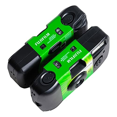 Two Fujifilm disposable cameras with green accents