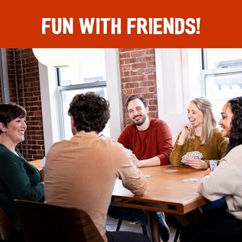 Group of friends playing cards at a table.