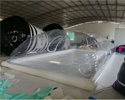 Transparent inflatable bubble tent inside a warehouse