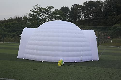 Large white inflatable dome on grass field