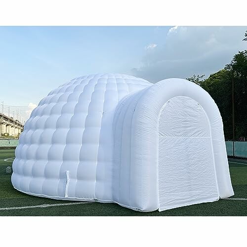 Large white inflatable igloo tent on grass