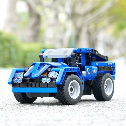 Blue LEGO off-road car model on pavement