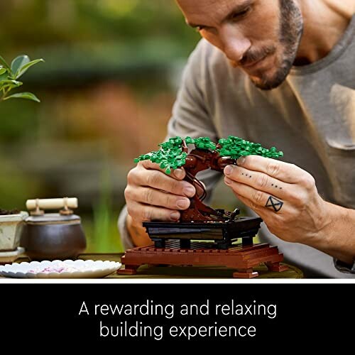 Person building a LEGO bonsai tree