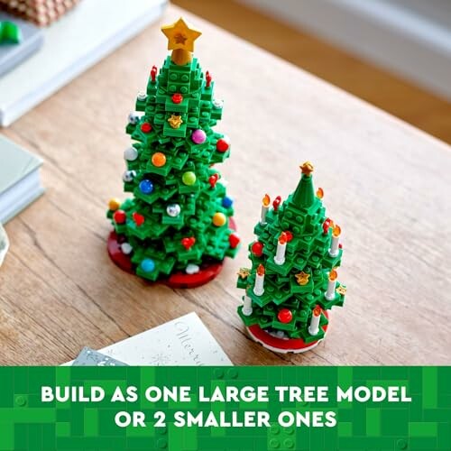 Two LEGO Christmas trees on a table, one large and one small.