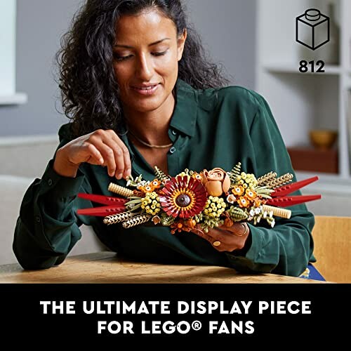 Person holding a floral LEGO display piece