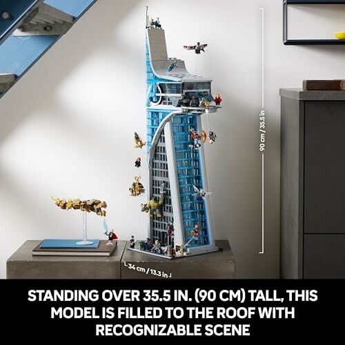 Tall Lego tower model with characters and scenes, standing on a table.