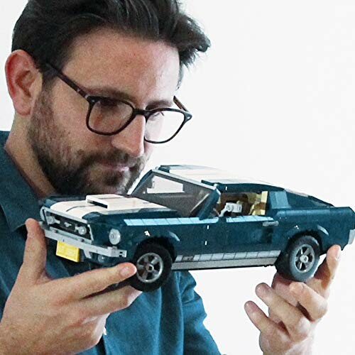 Man holding a model car