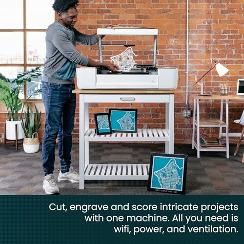 Man using a laser cutter in an industrial-style room.