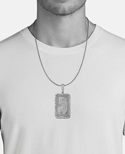 Man wearing a silver necklace with a rectangular pendant