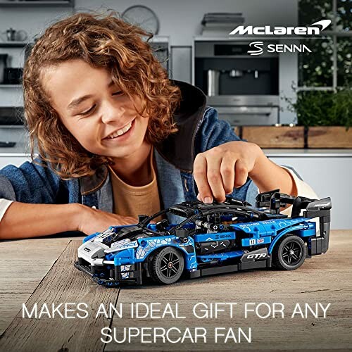 Child playing with McLaren Senna LEGO set on a table.