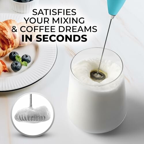 Milk frother in a glass of milk with pastries and blueberries on a plate.