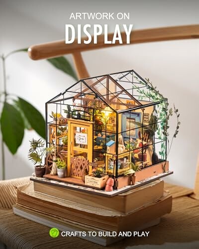 Intricate miniature greenhouse model with plants and furniture on display.