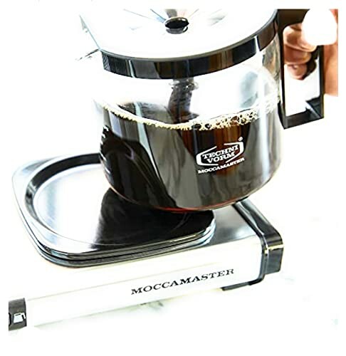 Moccamaster coffee maker with a glass carafe being lifted.