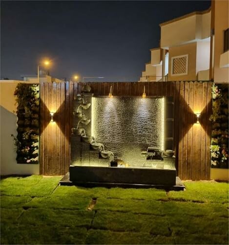 Modern garden water feature at night with lights