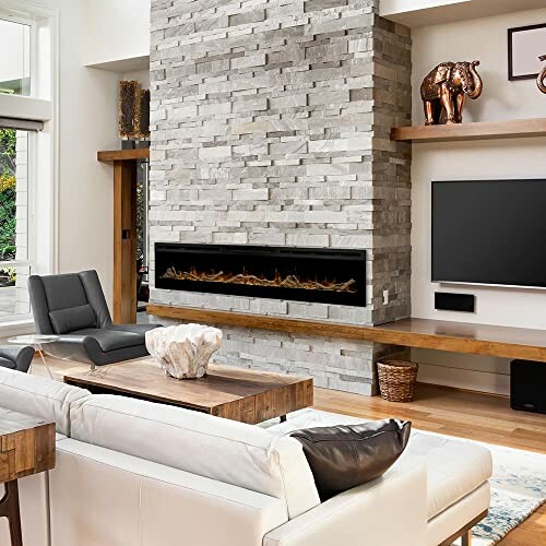 Modern living room with stone fireplace, TV, and stylish decor.