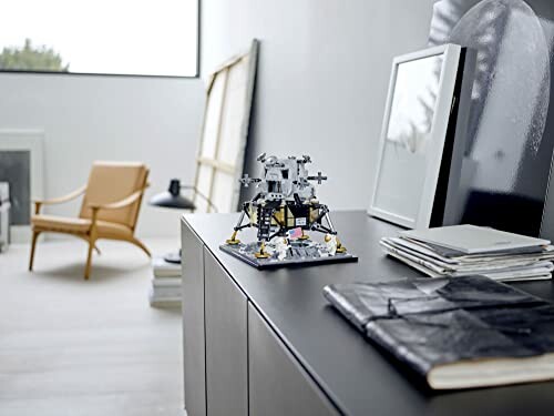 Modern room interior with a LEGO sculpture on a cabinet.