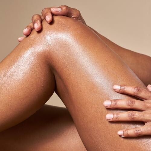 Close-up of moisturized legs and hands.