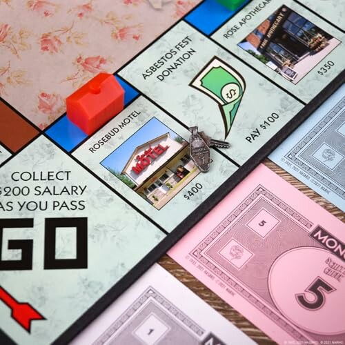 Close-up of a Monopoly board showing properties and game pieces.