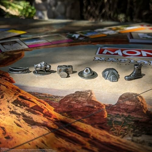 Monopoly game pieces on a board with scenic background.