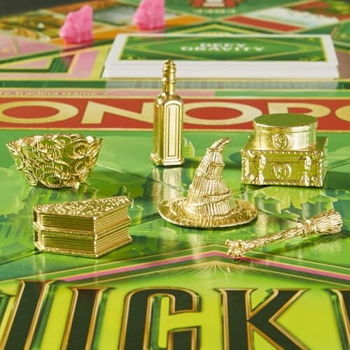 Gold Harry Potter-themed Monopoly tokens on a game board.