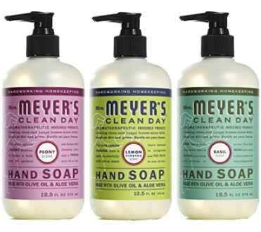 Three bottles of Mrs. Meyer's hand soap in peony, lemon, and basil scents.