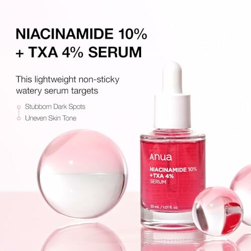 Niacinamide 10% TXA 4% serum bottle with pink liquid and glass spheres.