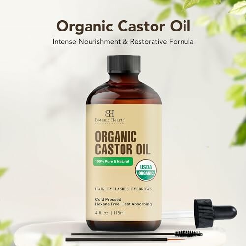 Organic castor oil bottle with dropper and brush.