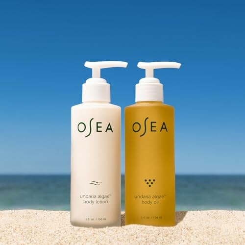 OSEA body lotion and oil bottles on beach.