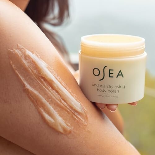 Person applying OSEA undaria cleansing body polish to arm