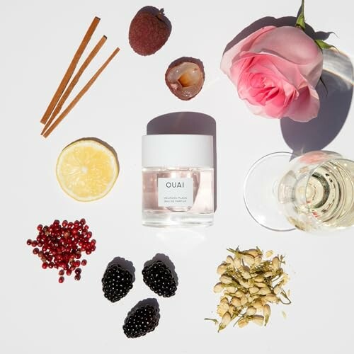 Flatlay of Ouai candle with rose, lychee, lemon, blackberries, and spices.